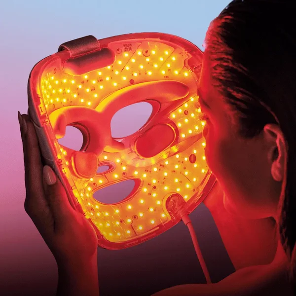 Woman using an LED face mask